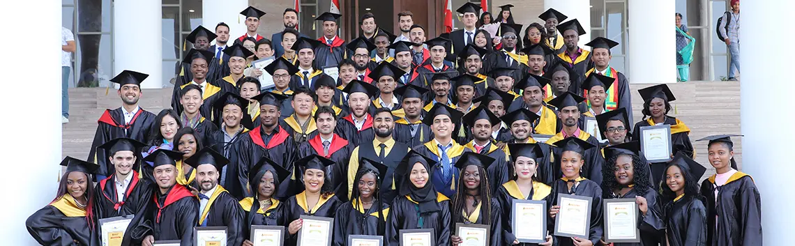 Group of students posing with their degree on convocation day